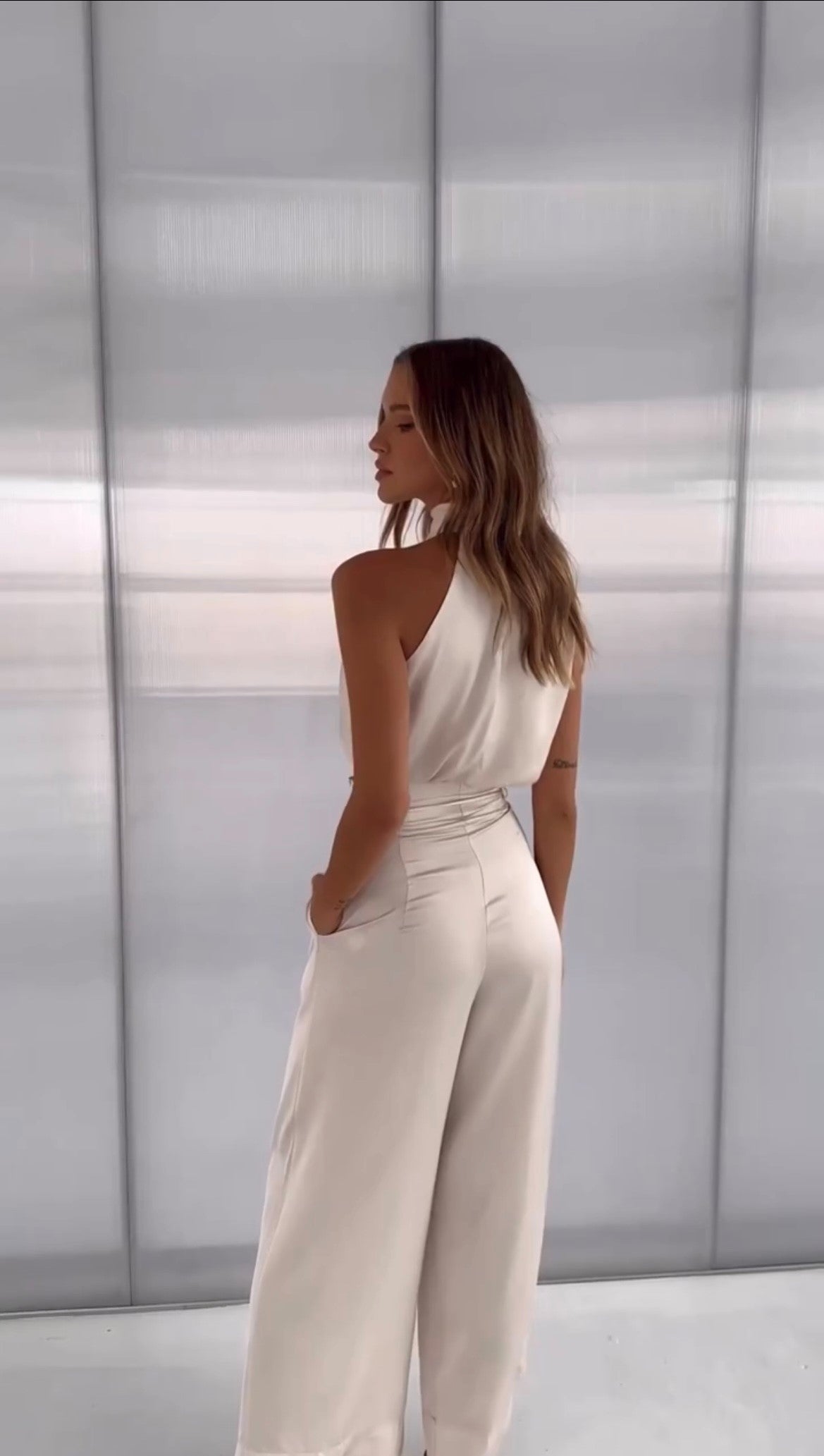 two-piece satin set with a halter top and wide-leg trousers