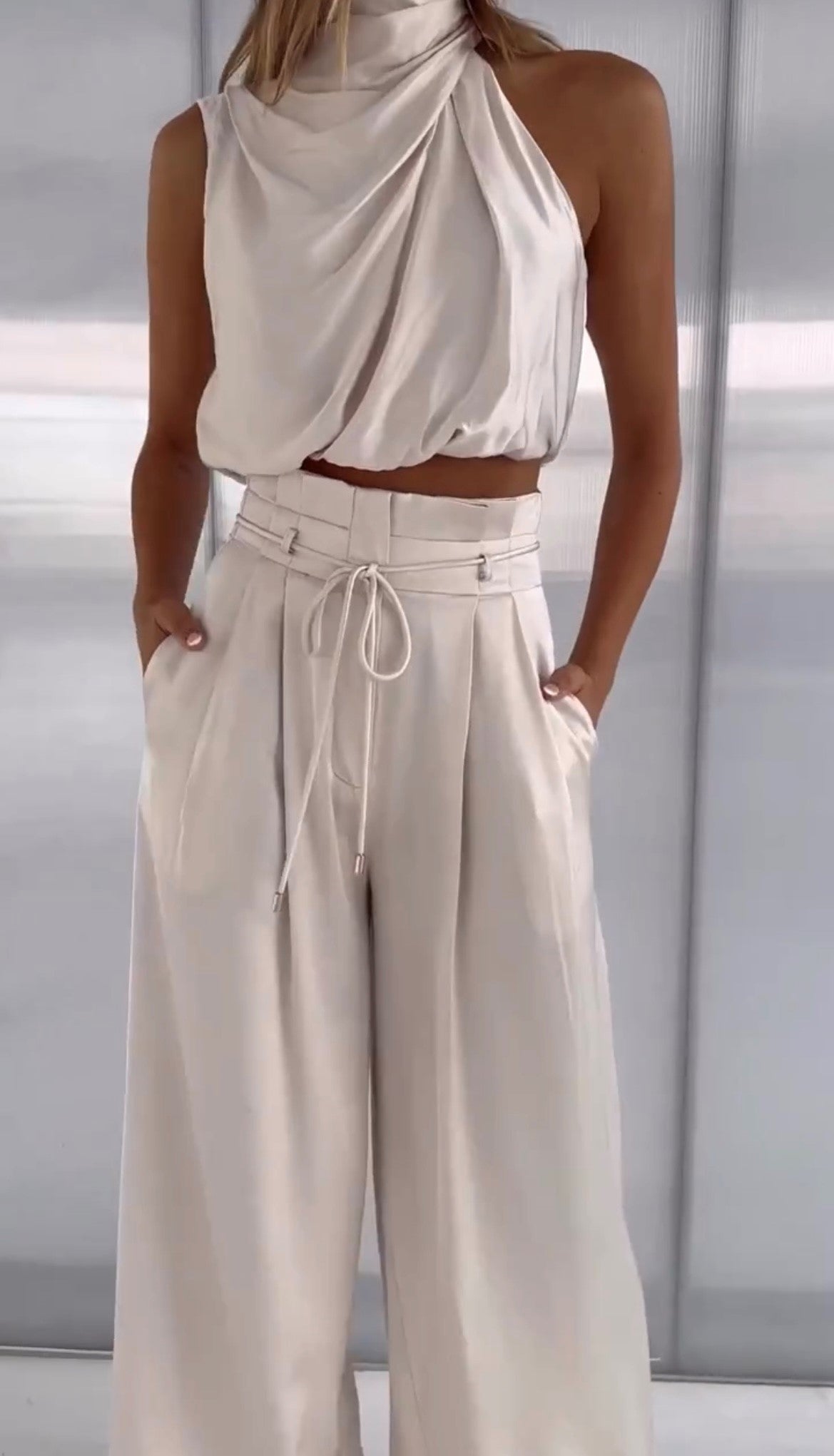 two-piece satin set with a halter top and wide-leg trousers